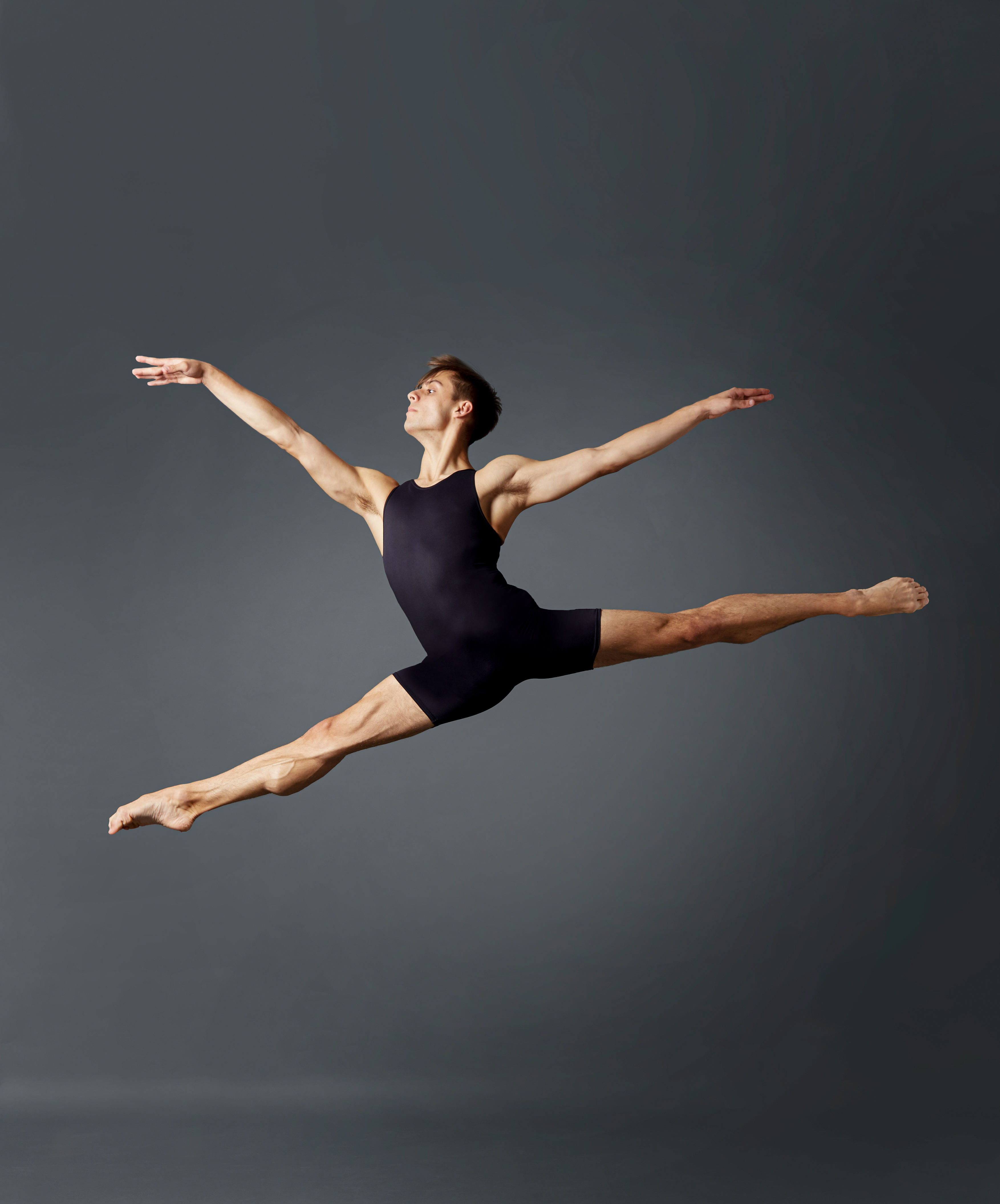 Male And Female Ballet Dancers In Mid Air Poses Arms Extended High-Res  Stock Photo - Getty Images